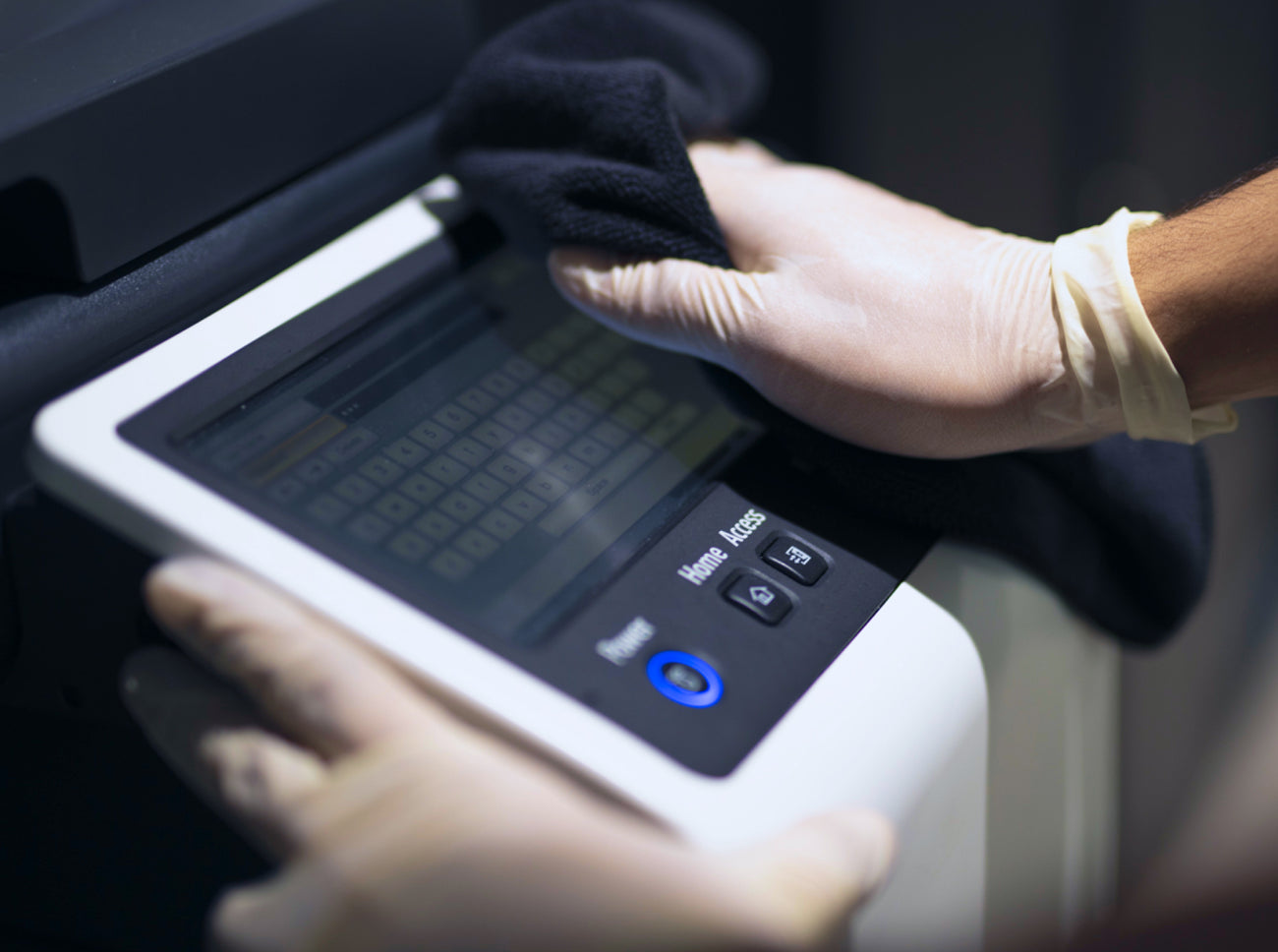 OVNU team wiping printer screen in an office